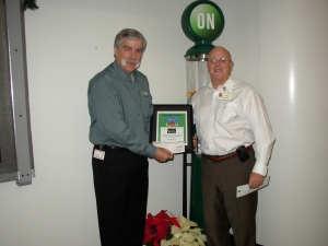 St. Mary's Food Bank Alliance CEO Terry Shannon and Bob Mahoney, ON Semiconductor Executive Vice President, Sales & Marketing and the gumball machine plaque. 